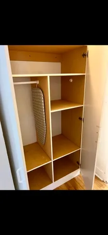 a view of walk in closet with clothes and window