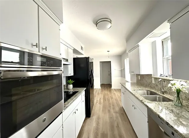 a kitchen with a sink stove and microwave