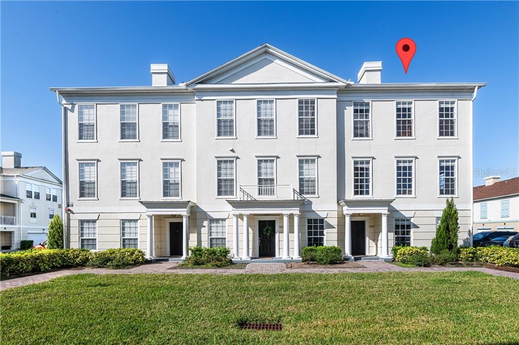 a front view of a building with a yard