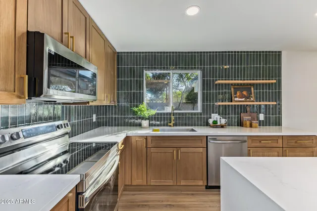 a kitchen with a sink and a stove top oven