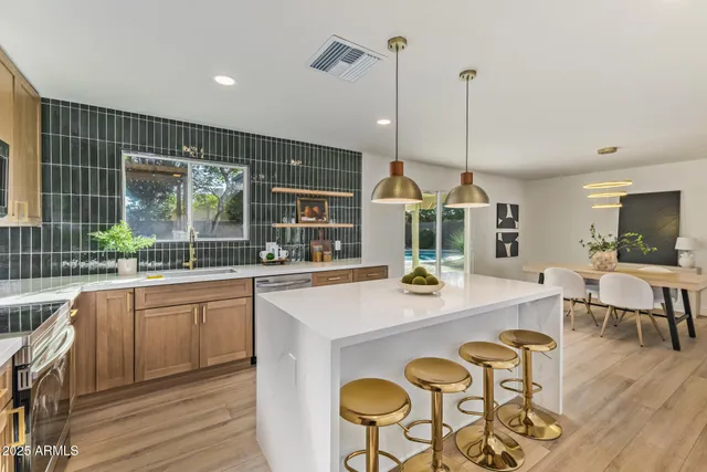 a view of a kitchen with a window and wooden floor
