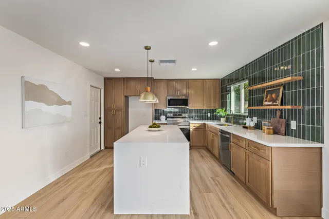 a kitchen with counter top space a sink and cabinets