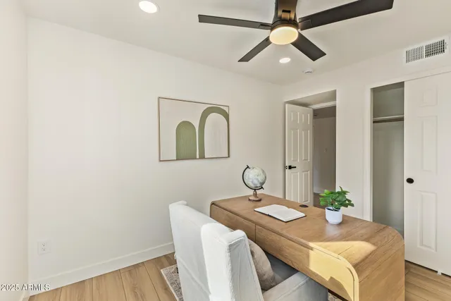 a view of a dining room with furniture and a chandelier fan