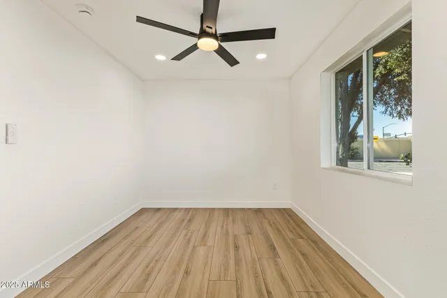 a view of a room with wooden floor and windows