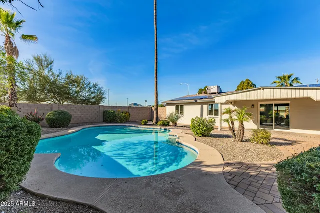 a view of a house with backyard porch and sitting area