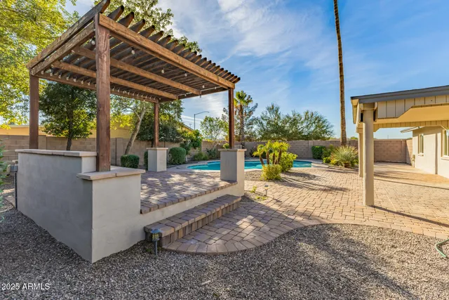 a view of a patio with table and chairs a barbeque with wooden fence