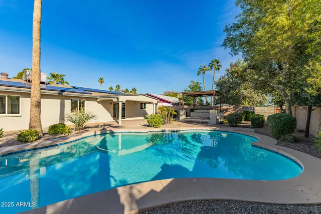 swimming pool view with a seating space