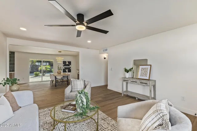 a living room with furniture and a wooden floor