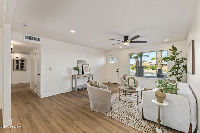 a living room with furniture and a wooden floor