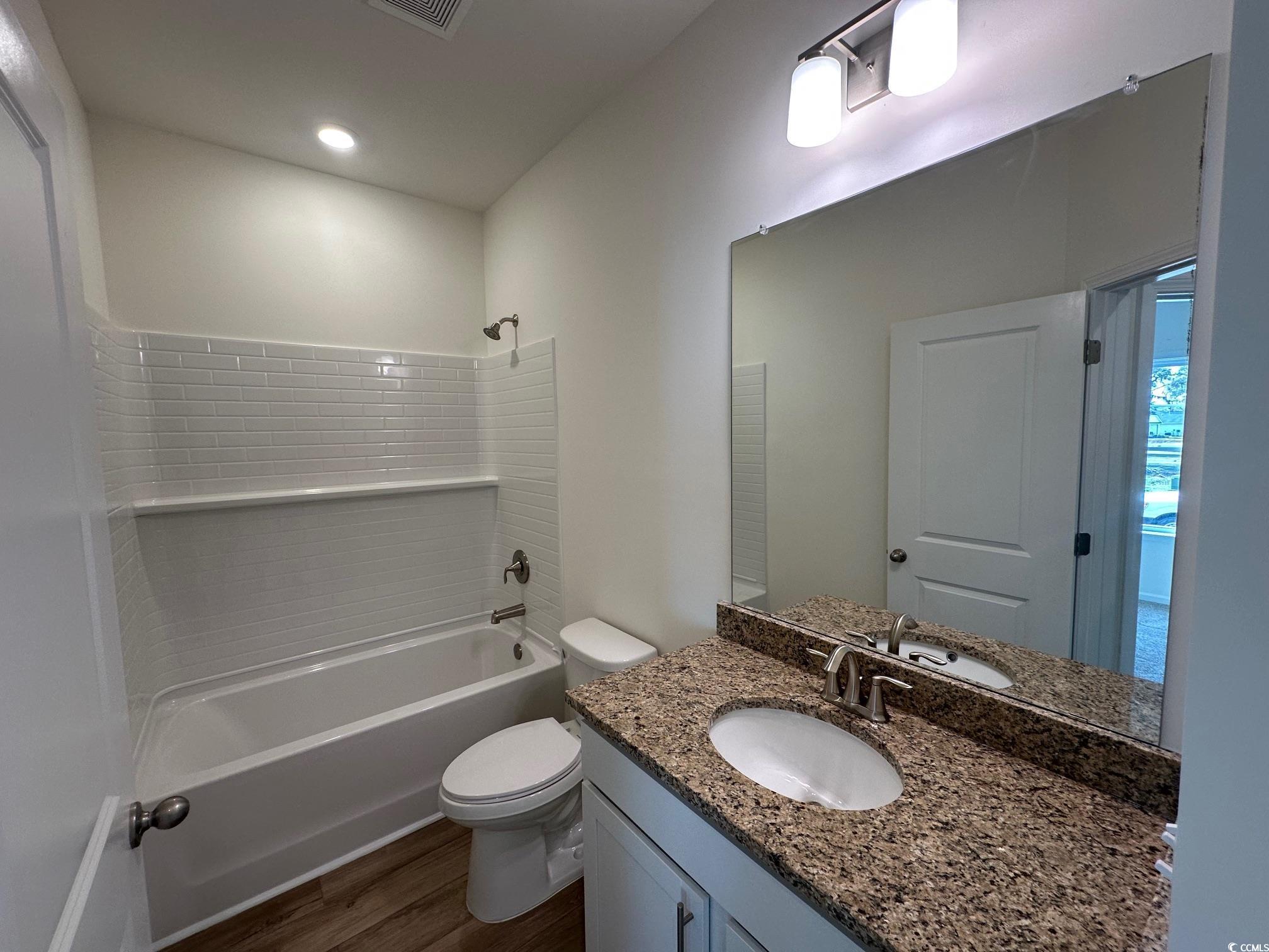 541 Honeyhill Loop Conway, SC 29526 - Photo 10 of 32 Full bathroom featuring vanity, wood finished floo