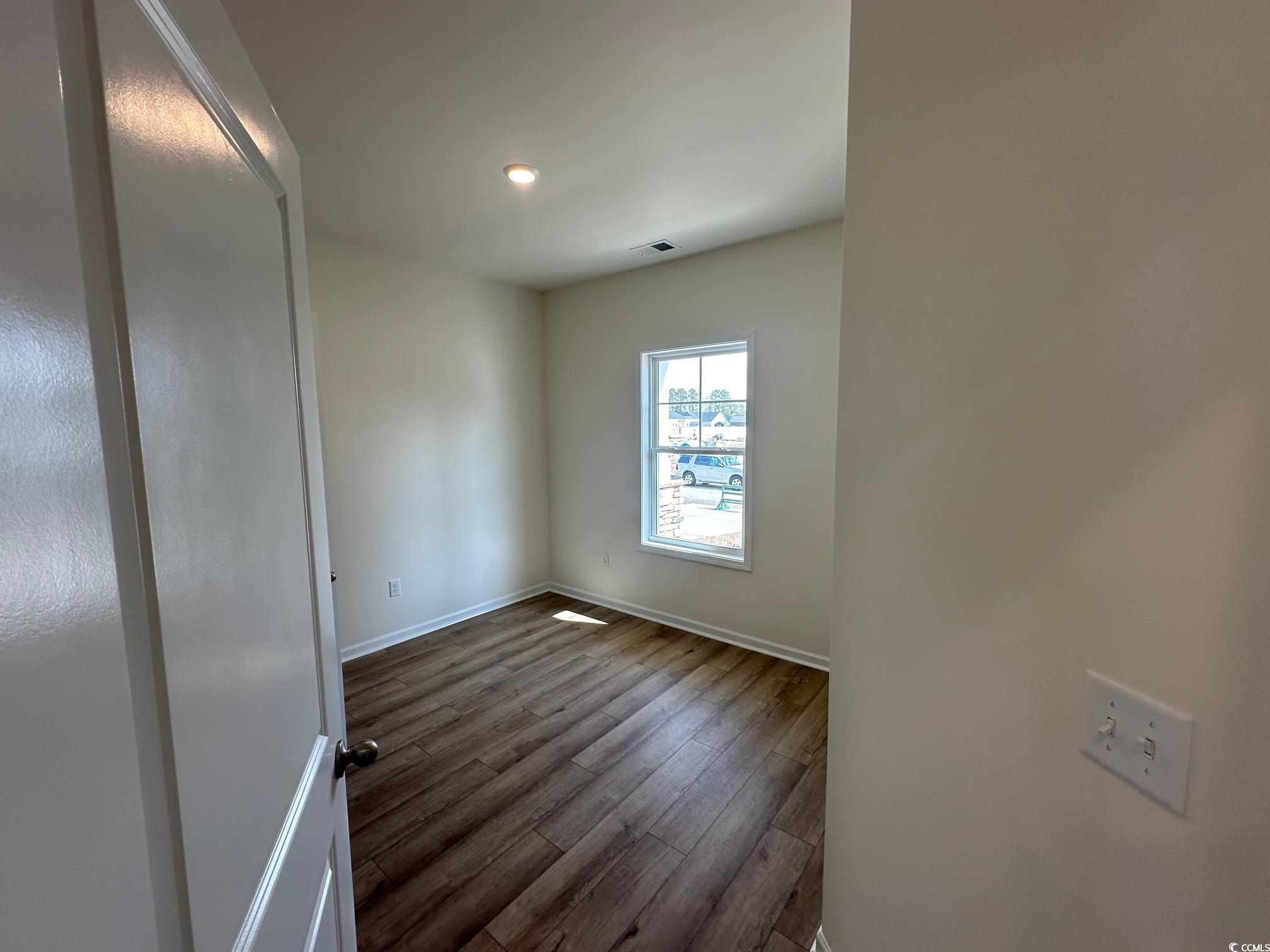 541 Honeyhill Loop Conway, SC 29526 - Photo 11 of 32 Spare room with dark wood-style floors, visible ve