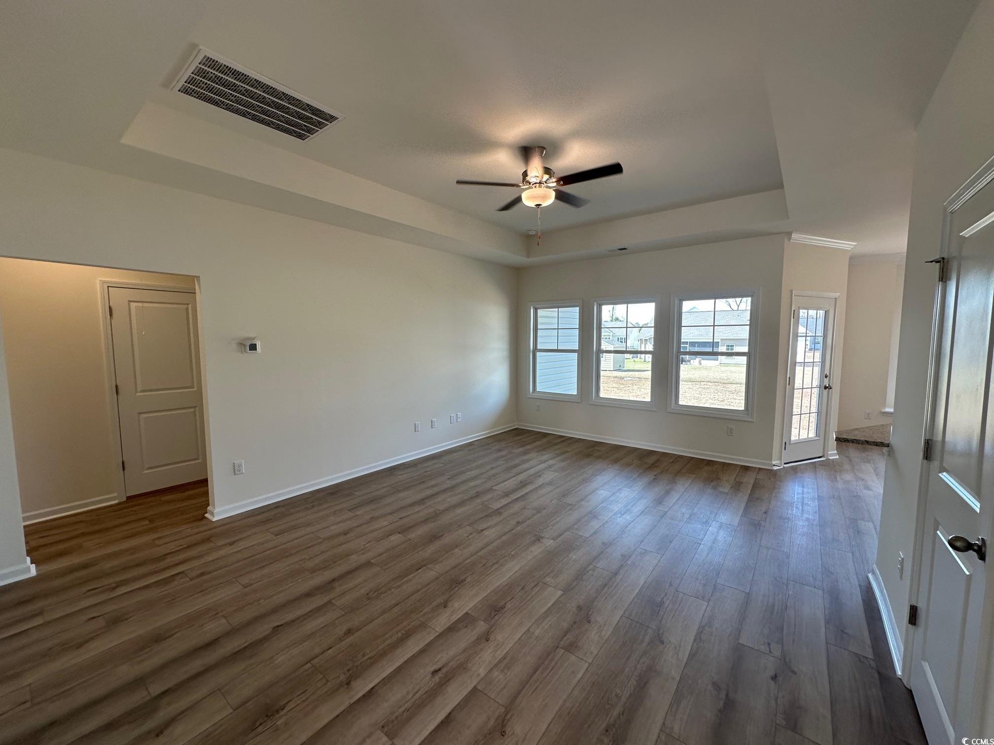 541 Honeyhill Loop Conway, SC 29526 - Photo 5 of 32 Empty room with visible vents, dark wood-type floo