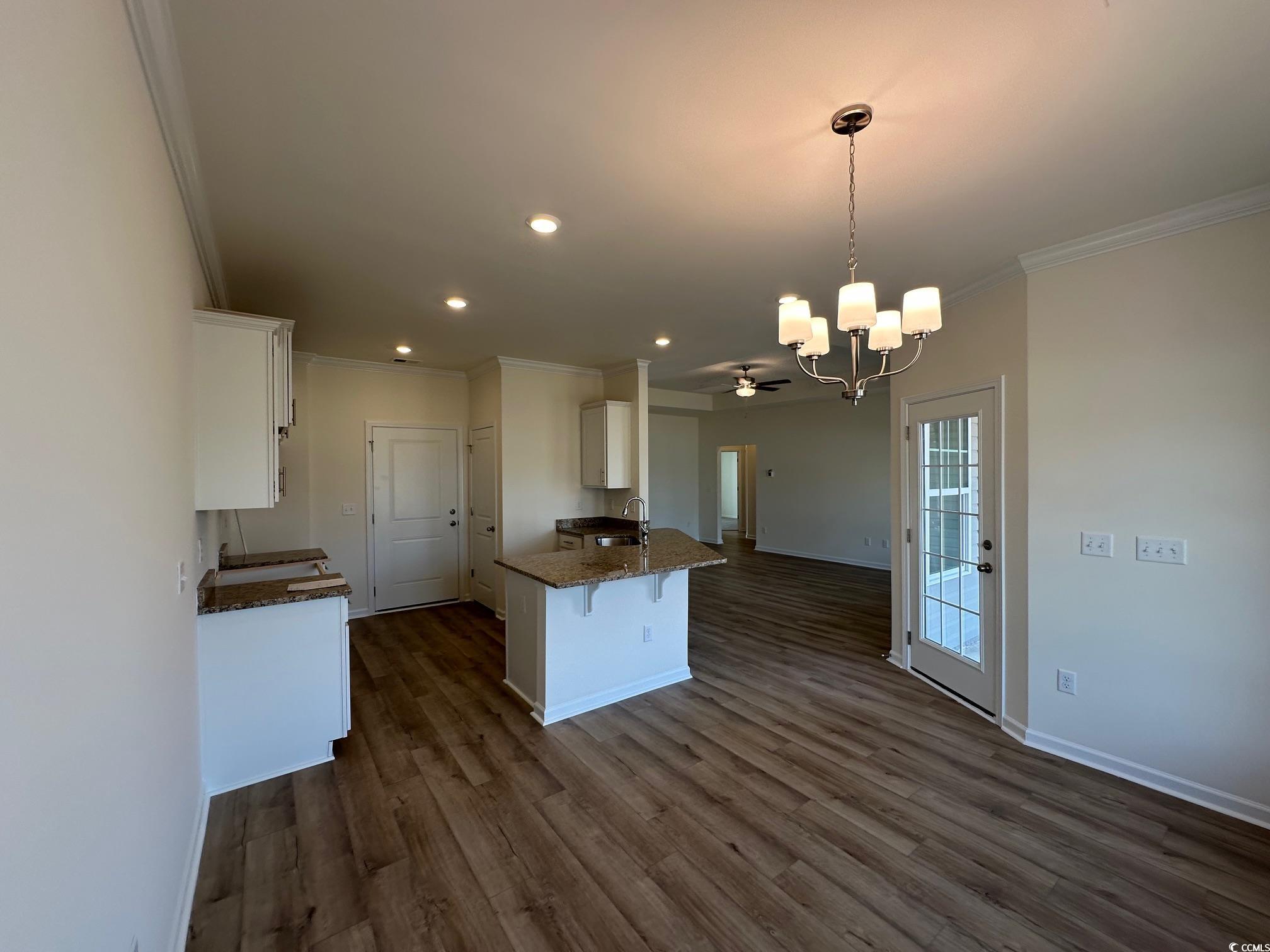 541 Honeyhill Loop Conway, SC 29526 - Photo 6 of 32 Kitchen with a sink, dark stone counters, white ca