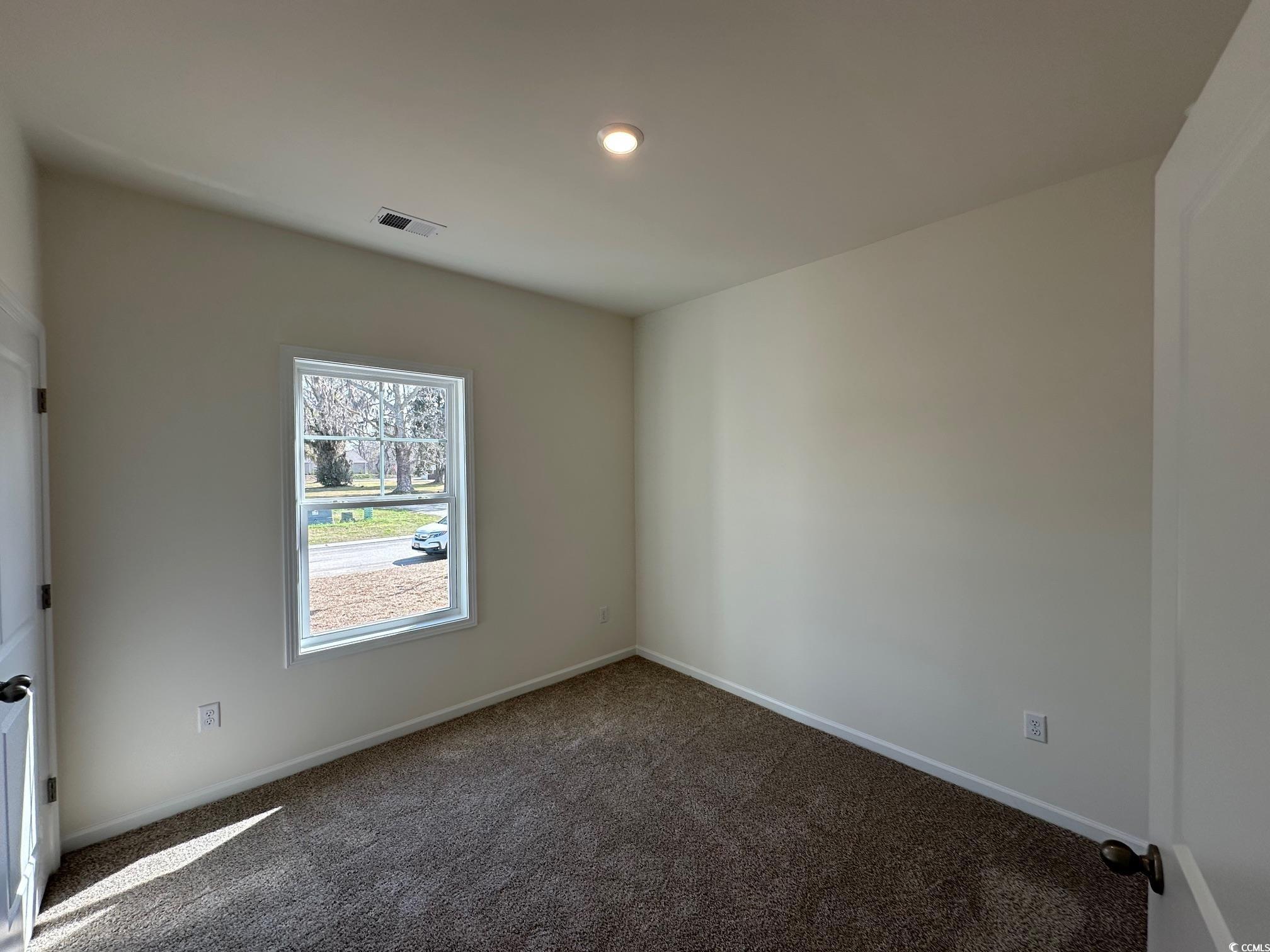 541 Honeyhill Loop Conway, SC 29526 - Photo 9 of 32 Spare room with visible vents, baseboards, and car