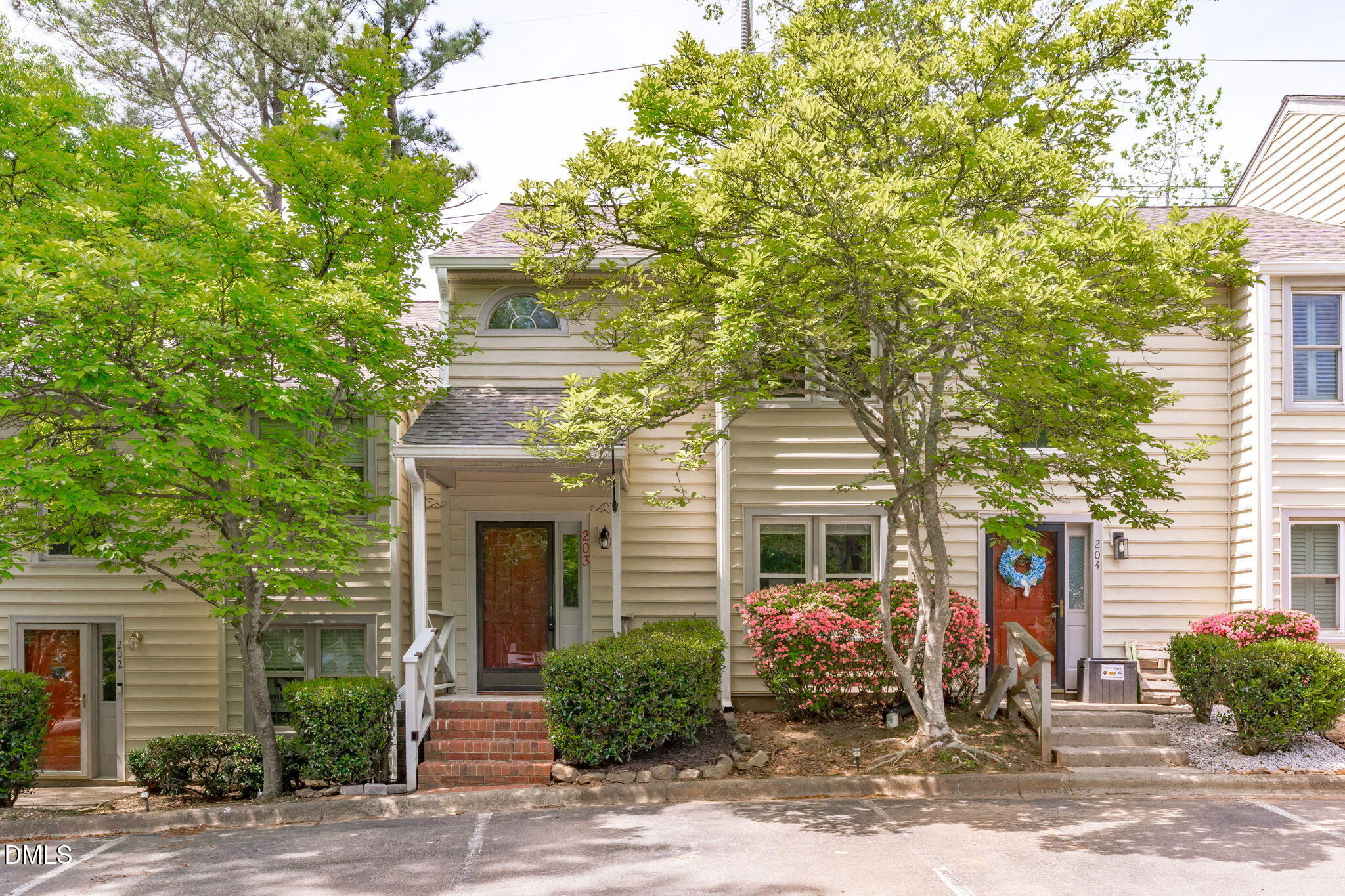 203 Oak Hollow Court Raleigh, NC 27613 - Photo 1 of 37 a front view of a house with garden