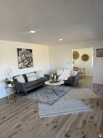 47 B Street Helper, UT 84526 - Photo 5 of 19 Living area featuring wood-finish flooring, recessed lighting, and an open archway to an additional room