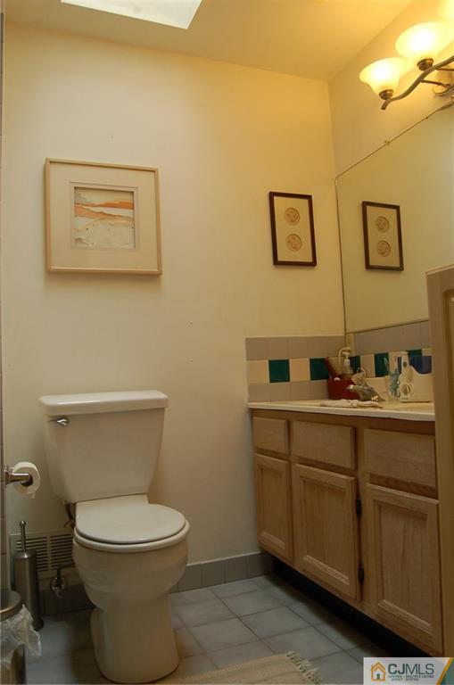 29 Chandler Road Edison, NJ 08820 - Photo 14 of 15 a bathroom with a toilet sink and mirror