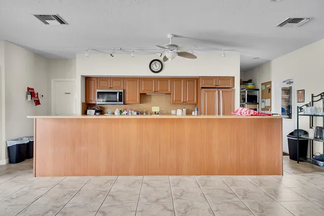 a aerial view of a house with a big yard and potted plants