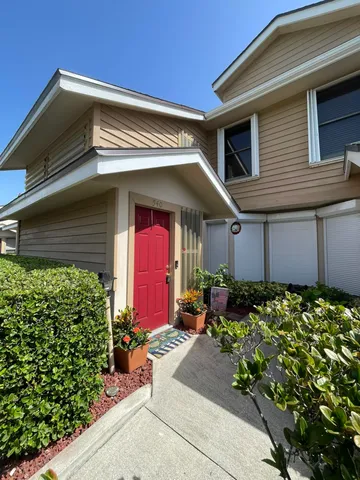 a bed room with a bed and a potted plant