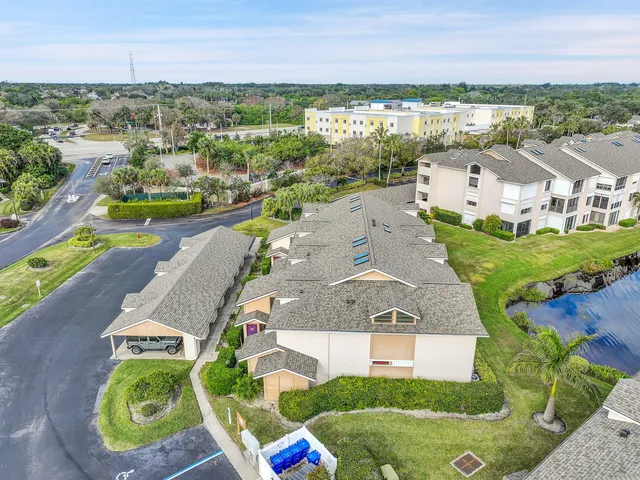 an aerial view of residential house with outdoor space and lake view