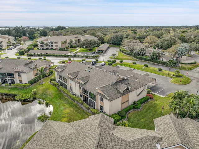 an aerial view of residential houses with outdoor space and parking
