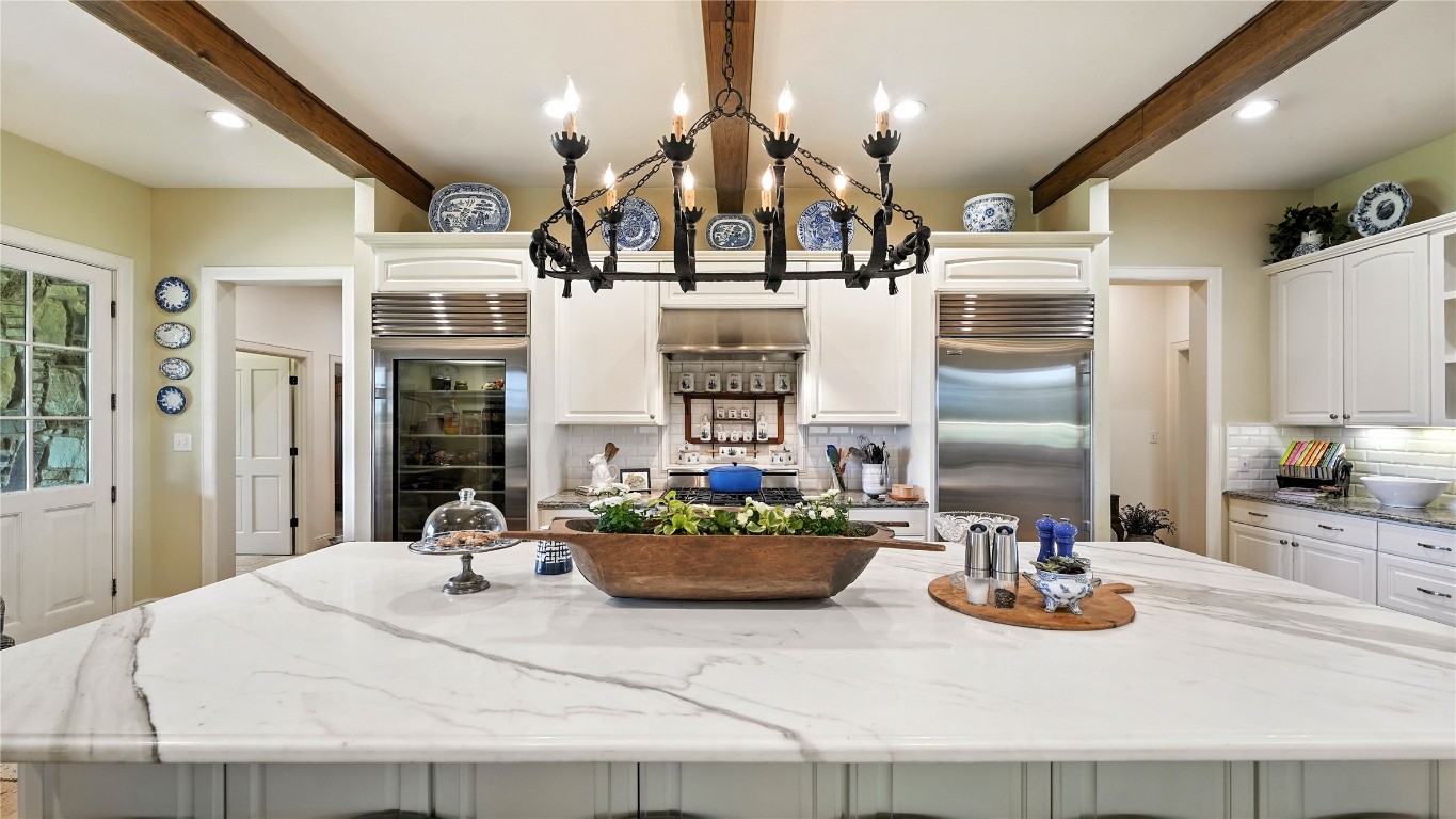 705 Antioch Road Paige, TX 78659 - Photo 14 of 40 a kitchen with sink refrigerator dining table and chairs