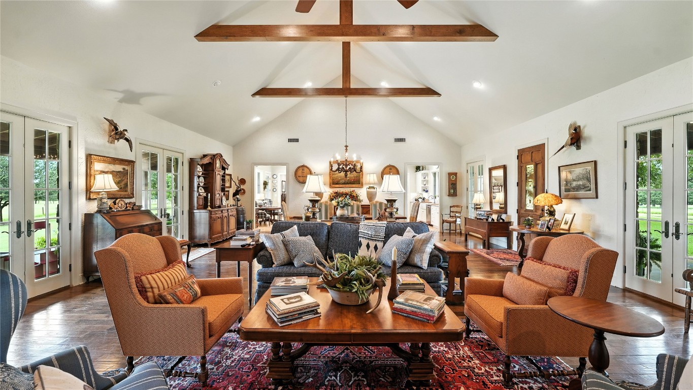 705 Antioch Road Paige, TX 78659 - Photo 16 of 40 a living room with lots of white furniture and a chandelier