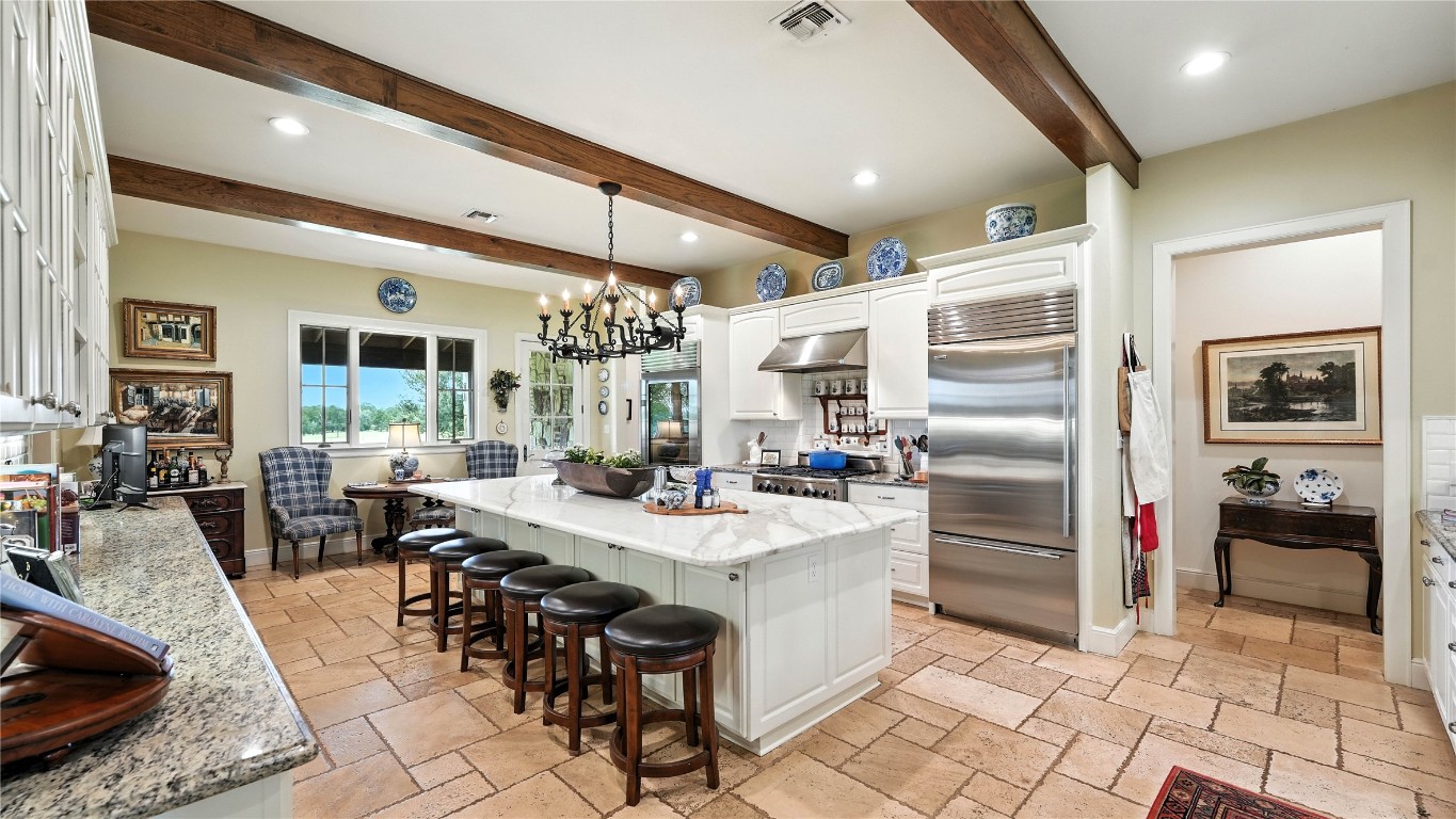 705 Antioch Road Paige, TX 78659 - Photo 17 of 40 a kitchen with stainless steel appliances granite countertop a sink stove and refrigerator
