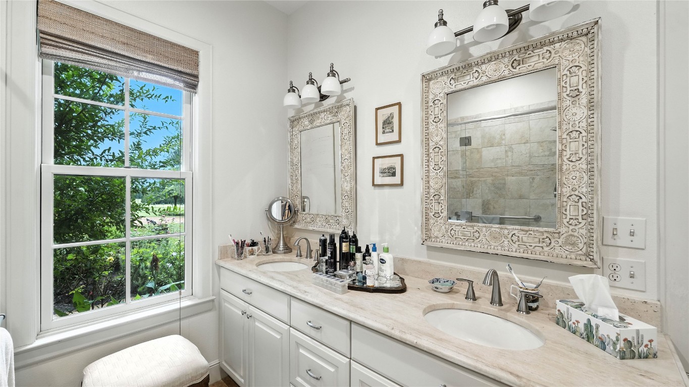 705 Antioch Road Paige, TX 78659 - Photo 22 of 40 a bathroom with a sink double vanity and a mirror