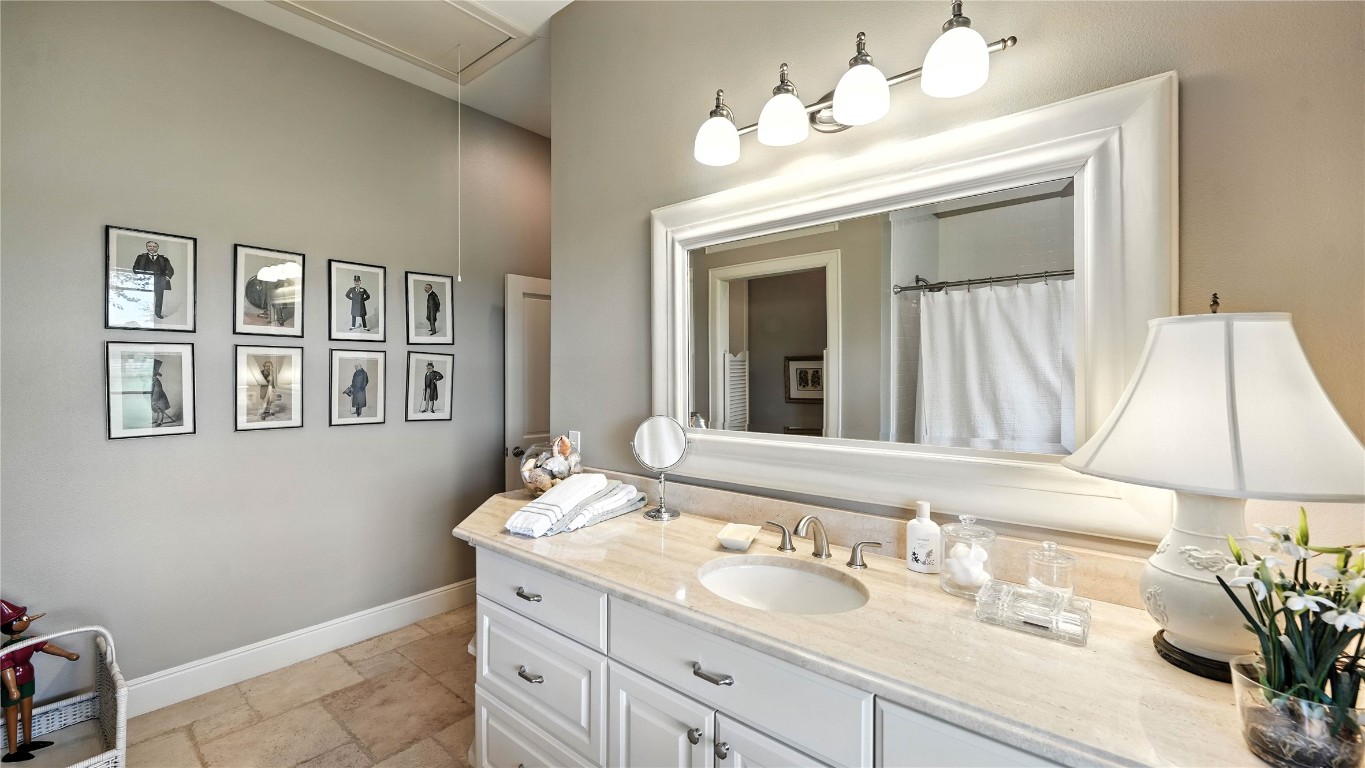 705 Antioch Road Paige, TX 78659 - Photo 26 of 40 a bathroom with a double vanity sink and a mirror