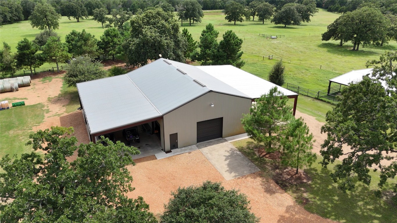 705 Antioch Road Paige, TX 78659 - Photo 30 of 40 an aerial view of a house with a yard and lake view