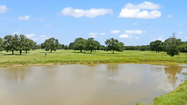 705 Antioch Road Paige, TX 78659 - Photo 36 of 40 a view of a lake with a big yard
