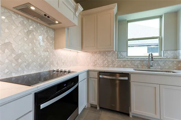 a kitchen with a sink stove and cabinets
