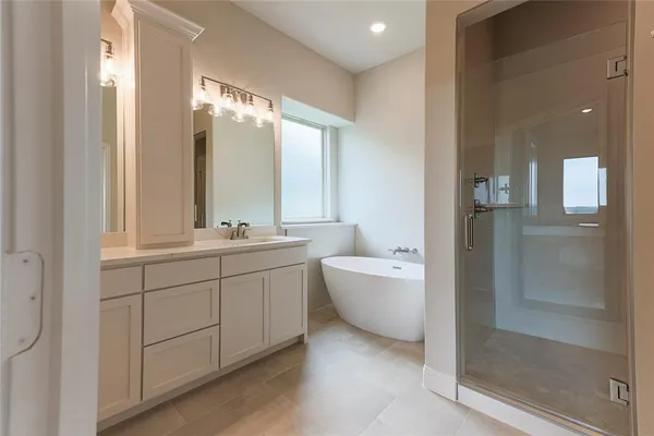 a large bathroom with a double vanity sink mirror and shower