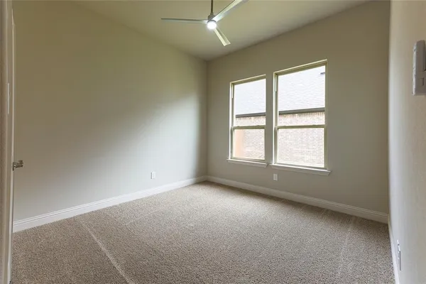 an empty room with windows and closet