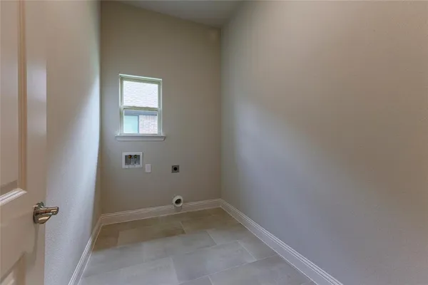 a view of a small space with wooden floor and a window