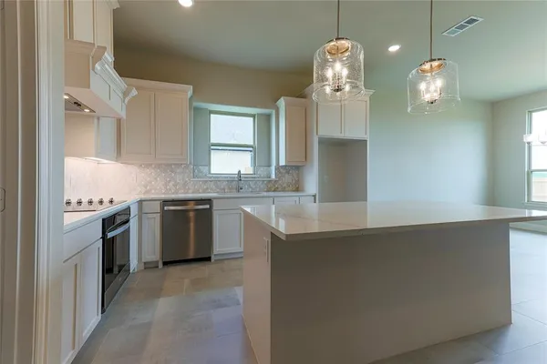 a kitchen with a sink and chandelier