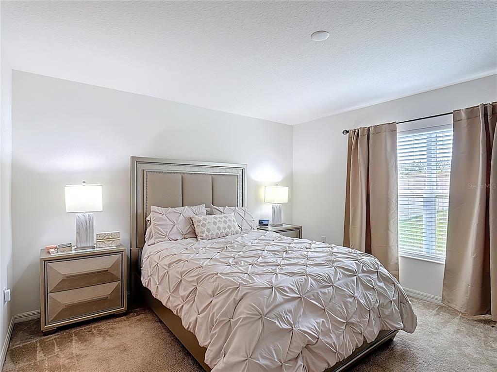 3216 Casa Del Rey Avenue Kissimmee, FL 34746 - Photo 15 of 32 a bedroom with a bed and a window