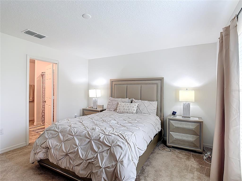 3216 Casa Del Rey Avenue Kissimmee, FL 34746 - Photo 16 of 32 a bedroom with a bed and a lamp