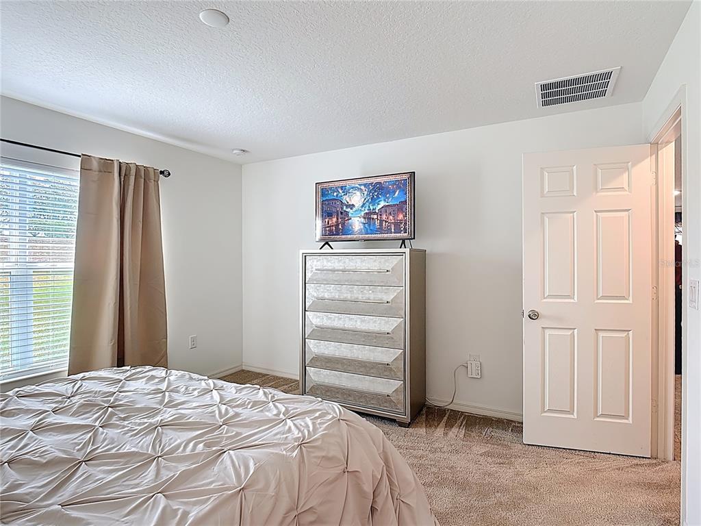 3216 Casa Del Rey Avenue Kissimmee, FL 34746 - Photo 17 of 32 a bedroom with a bed and a window