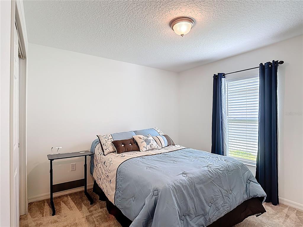3216 Casa Del Rey Avenue Kissimmee, FL 34746 - Photo 21 of 32 a bedroom with a bed and a window