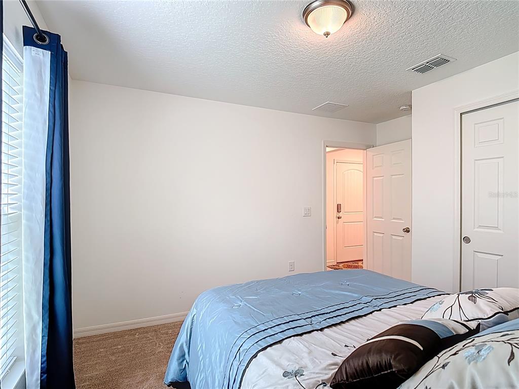 3216 Casa Del Rey Avenue Kissimmee, FL 34746 - Photo 22 of 32 a bedroom with a bed and a window