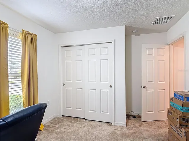 a view of room with window and hallway