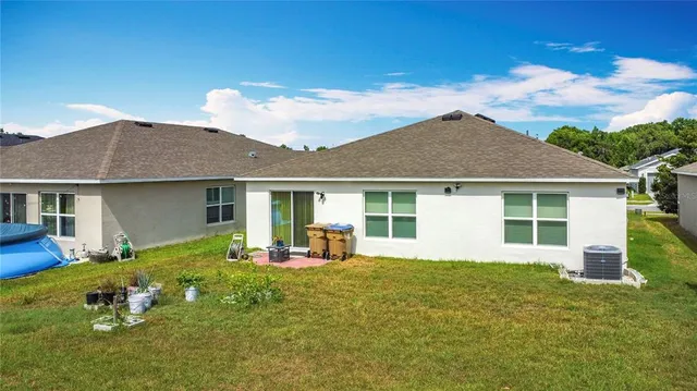 a front view of a house with a garden and yard