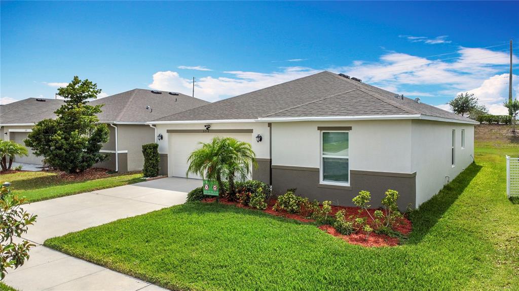 3216 Casa Del Rey Avenue Kissimmee, FL 34746 - Photo 30 of 32 a front view of a house with a garden