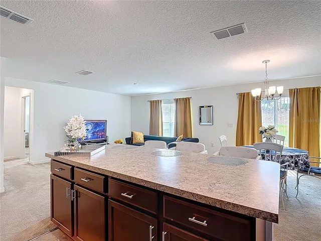 a view of kitchen island a sink and living room