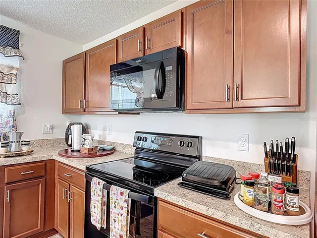 a kitchen with stainless steel appliances granite countertop a stove and cabinets