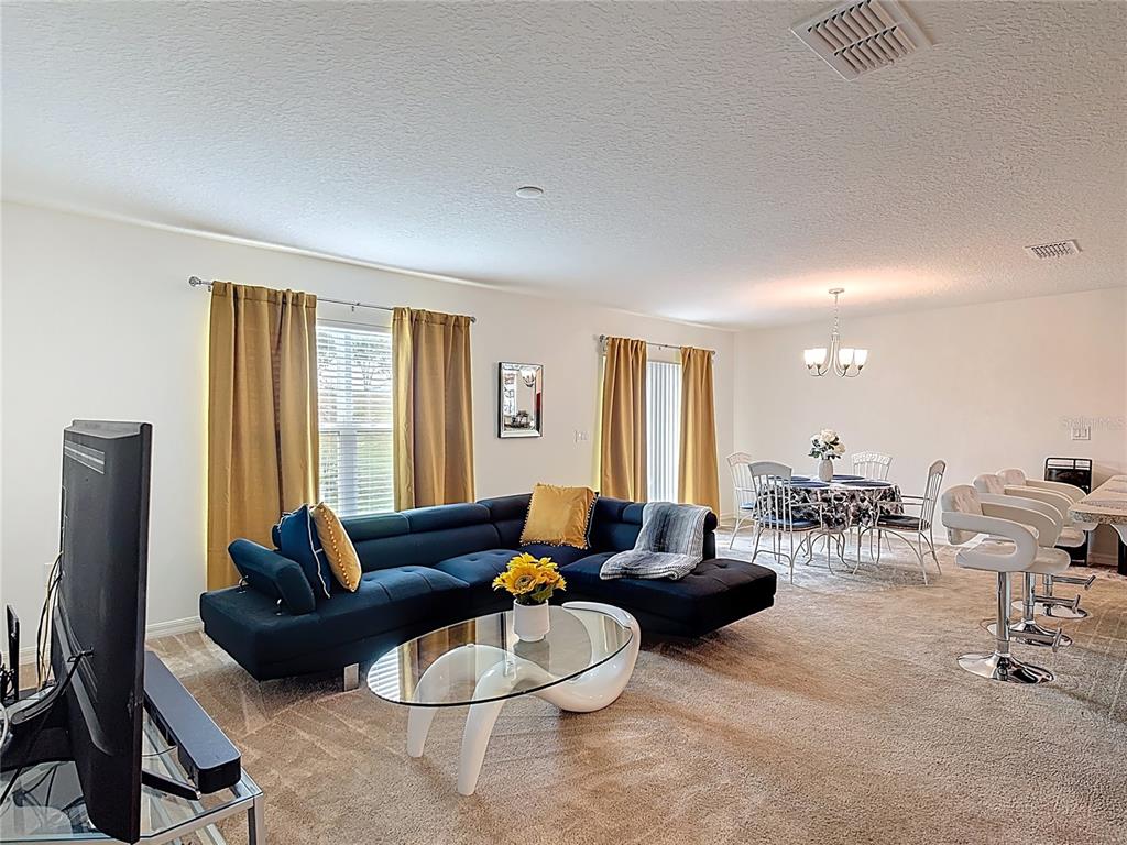 3216 Casa Del Rey Avenue Kissimmee, FL 34746 - Photo 8 of 32 a living room with furniture and a large window