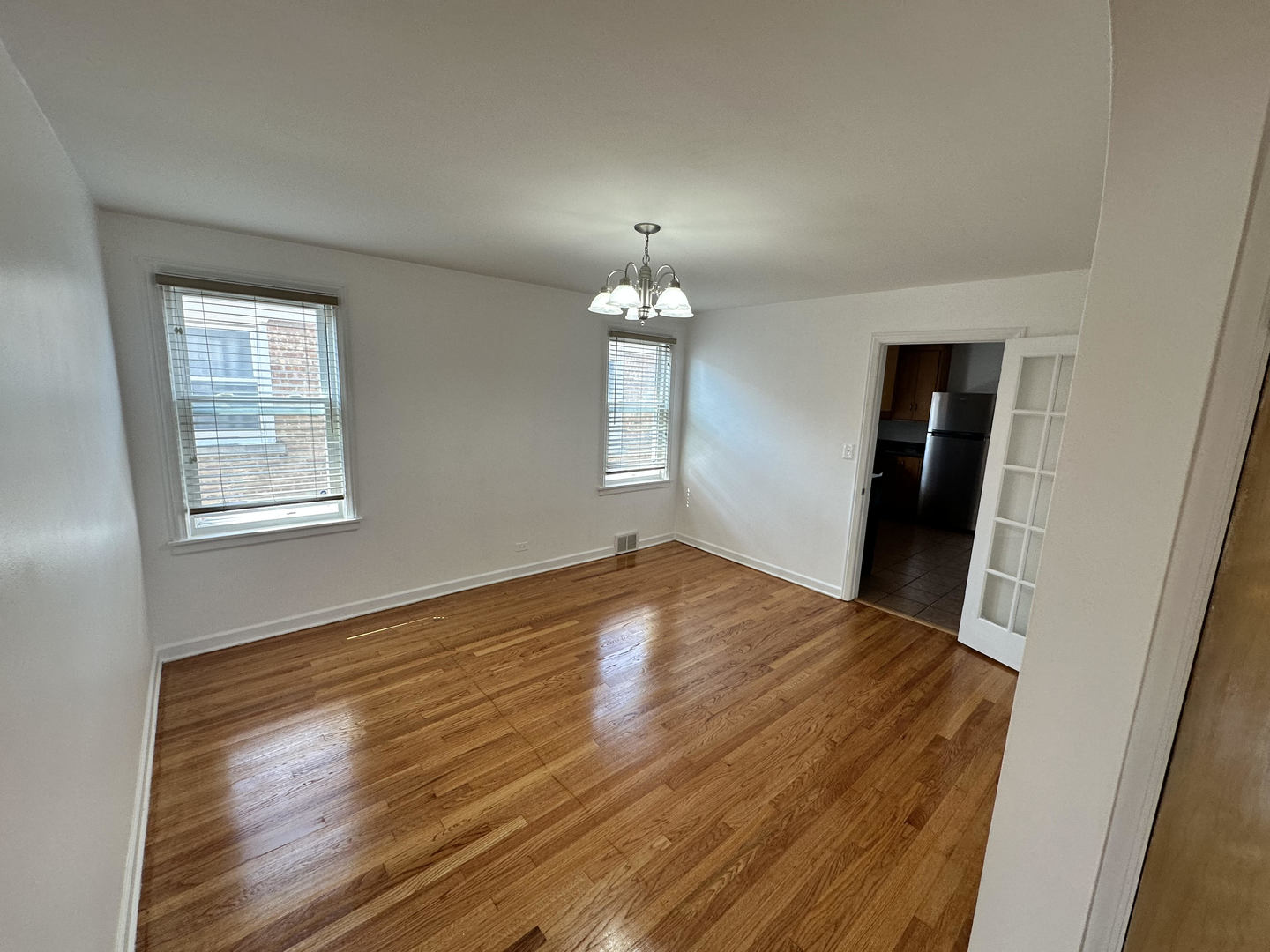5658 North Richmond Street, Unit 2 Chicago, IL 60659 - Photo 4 of 12 a view of empty room with wooden floor and fan