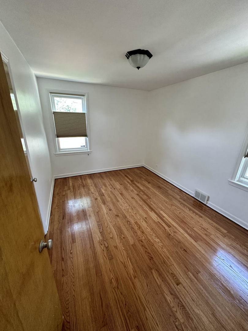 5658 North Richmond Street, Unit 2 Chicago, IL 60659 - Photo 9 of 12 wooden floor in an empty room